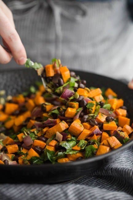 Tossing the black bean salad