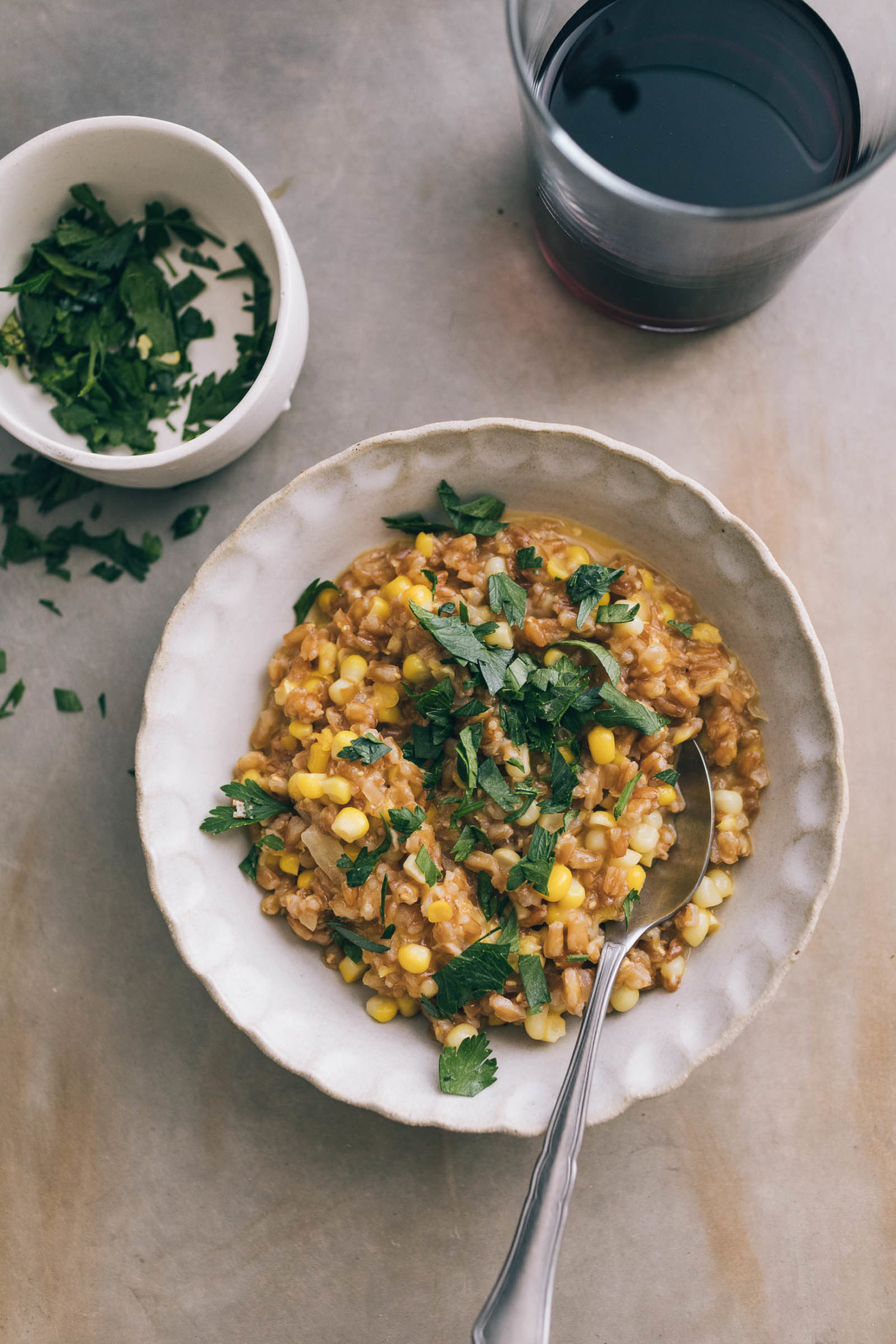 Overhead shot of sweet corn farro risotto topped with parsley