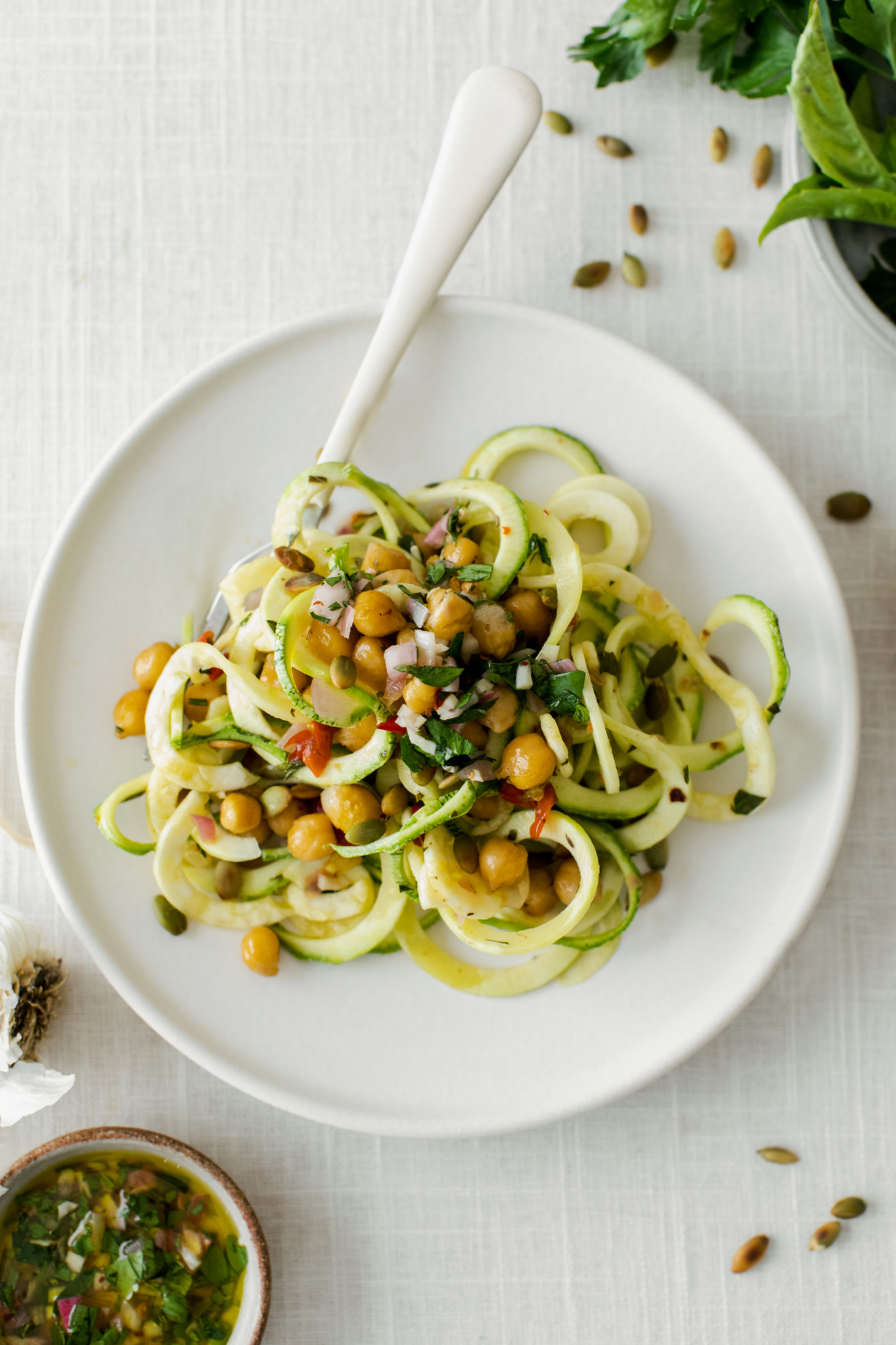 overhead shot of zucchini noodles tossed with a chimichurri chickpea mix