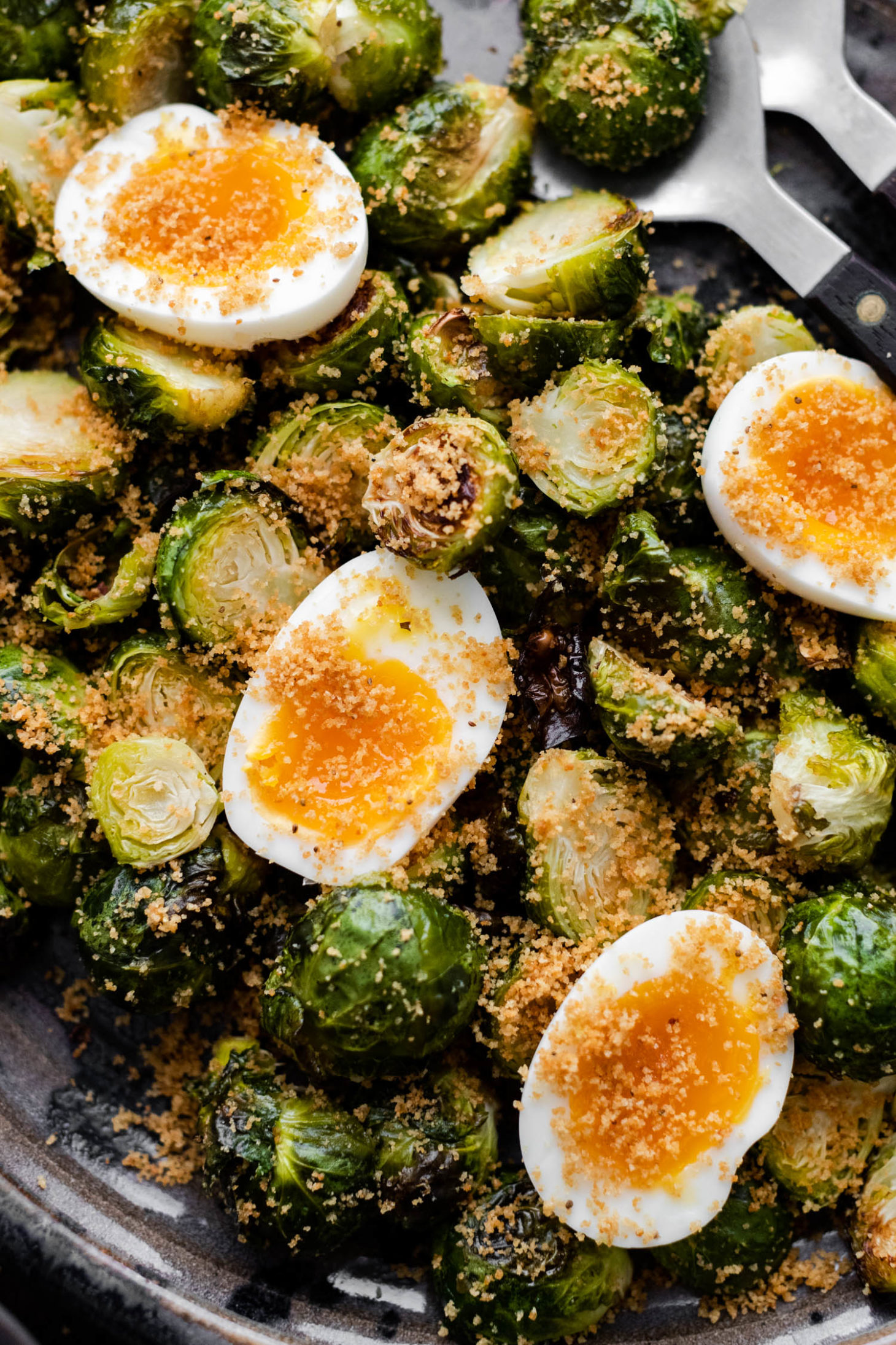 Close-up overhead shot of oven roasted Brussels sprouts and soft-boiled eggs