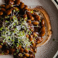 Photograph of Vegan Baked Beans on Toast, topped with microgreens