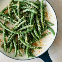 Overhead photo of green beans in a white enamel pan.