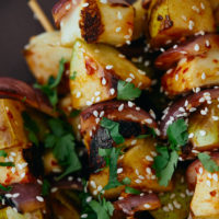 Close-up image of grilled pear skewers.