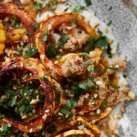 Close-up photo of roasted delicata squash tossed with cooked amaranth.