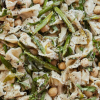 Close-up side photo of a asparagus pasta salad with chickpeas and farfalle pasta